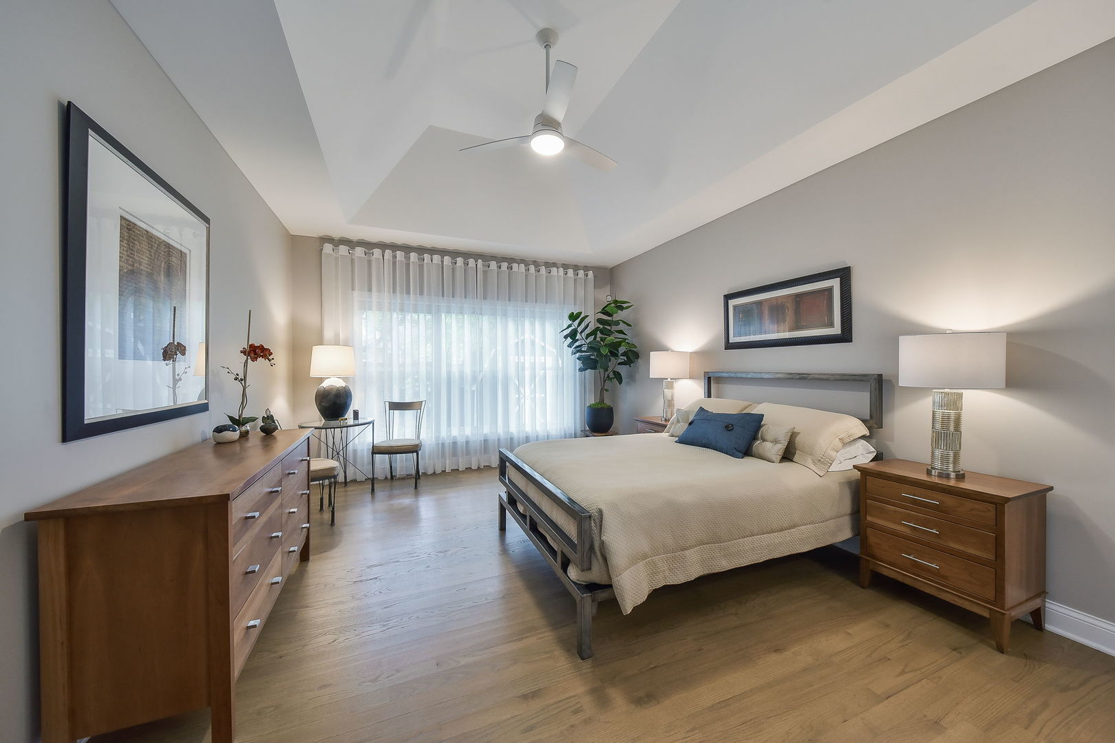 436 East Hillside Road Naperville, IL 60540 - Photo 23 of 59 a spacious bedroom with a bed a table and painting