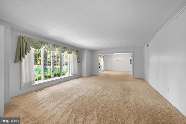 a view of an empty room with large windows