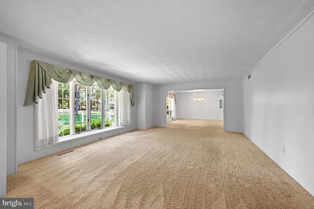 a view of an empty room with large windows