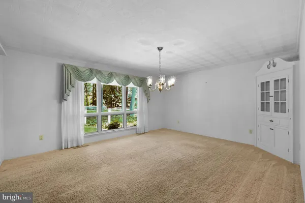 a view of a room with windows and ceiling fan