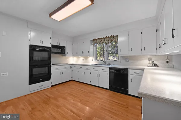 a kitchen with stainless steel appliances a refrigerator sink and cabinets