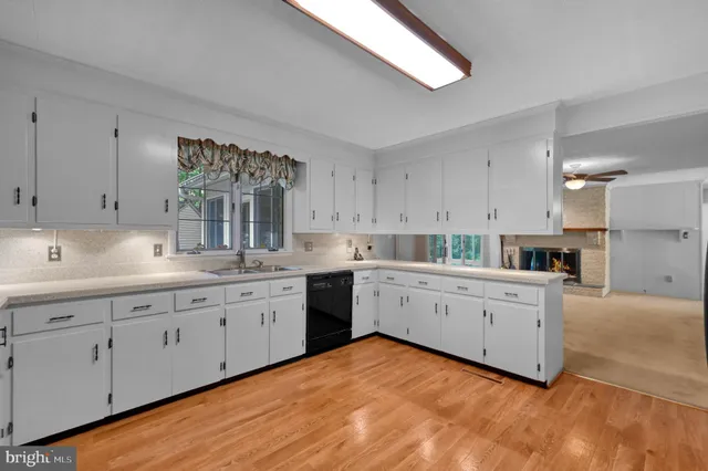 a kitchen with sink cabinets and window