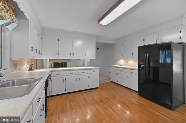 a kitchen with a sink cabinets and stainless steel appliances