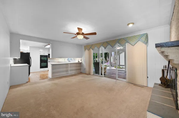 a view of a kitchen with furniture and floor to ceiling window