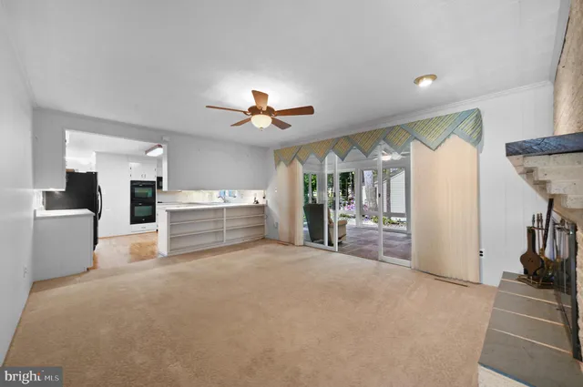 a view of a kitchen with furniture and floor to ceiling window