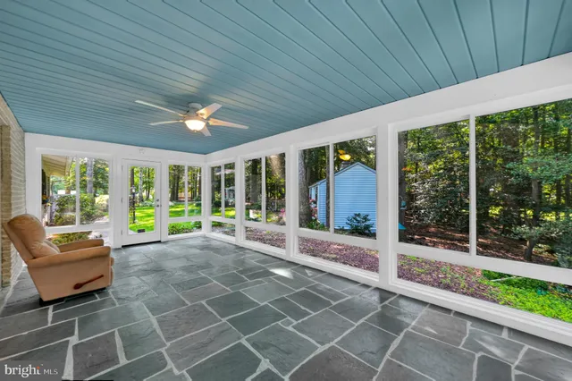 a living room with patio furniture and garden