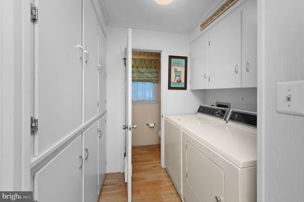 a view of a storage and utility room with washer and dryer