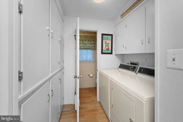 a view of a storage and utility room with washer and dryer