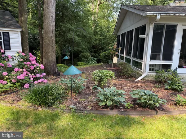 a view of a house with pool and garden