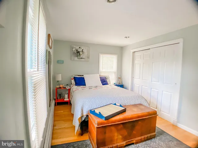 a room with a bed and wooden floor