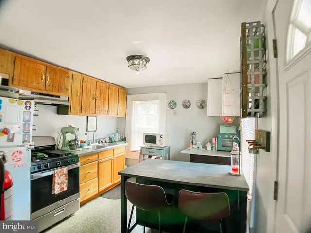 a kitchen with a sink cabinets and window