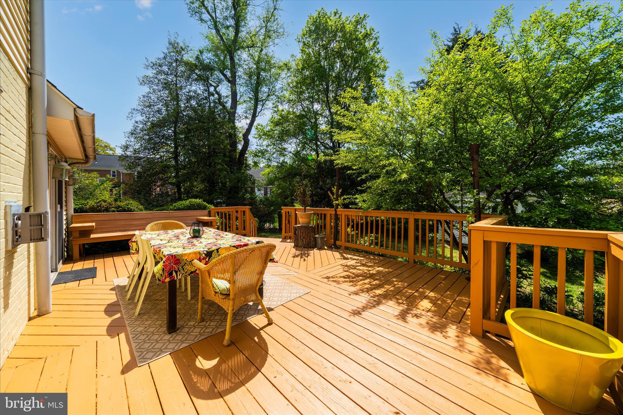 9300 Mintwood Street Silver Spring, MD 20901 - Photo 106 of 115 a view of a patio with dining table and chairs with wooden floor and fence