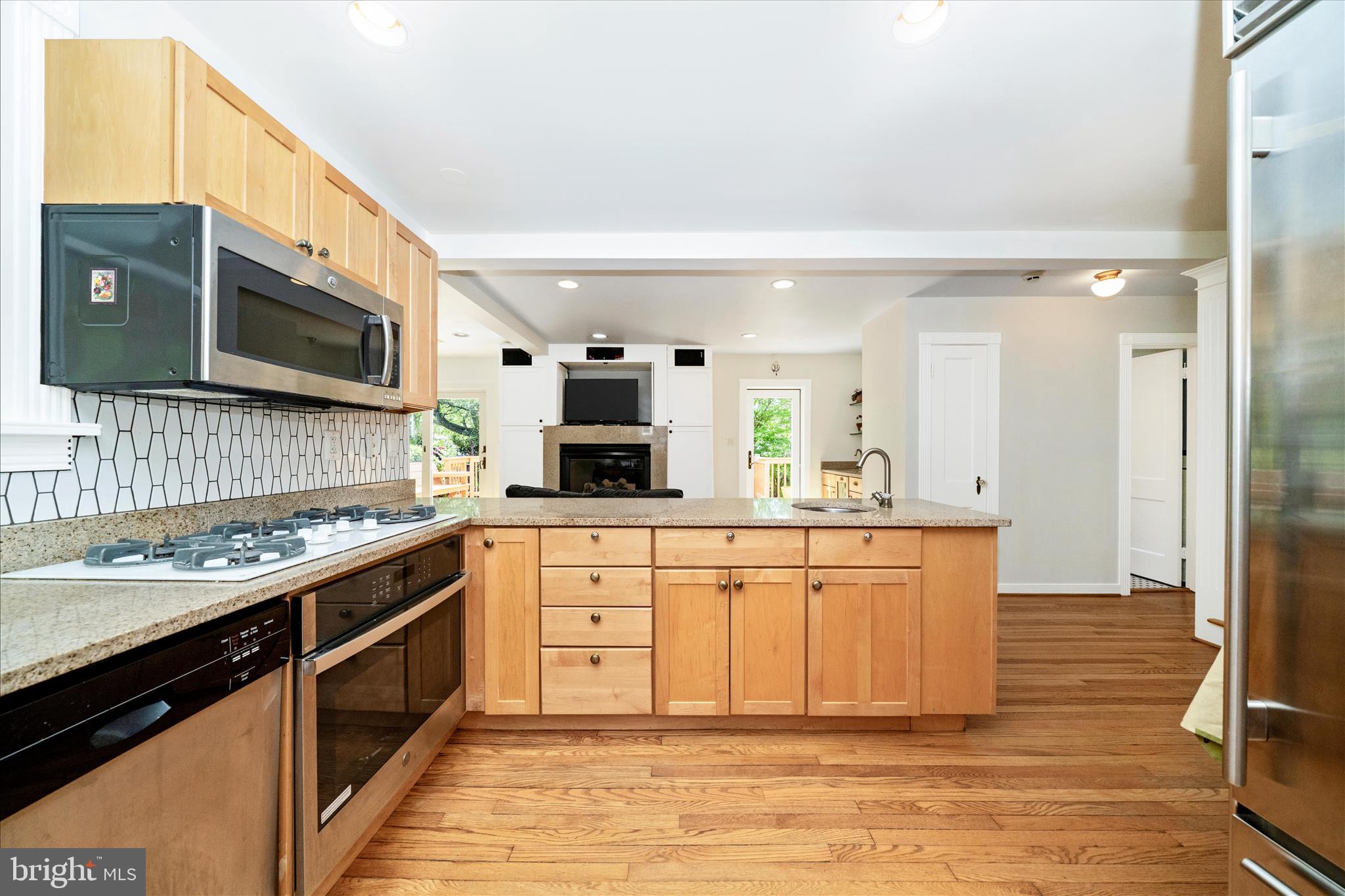 9300 Mintwood Street Silver Spring, MD 20901 - Photo 11 of 115 a kitchen with stainless steel appliances granite countertop a stove a sink and a microwave