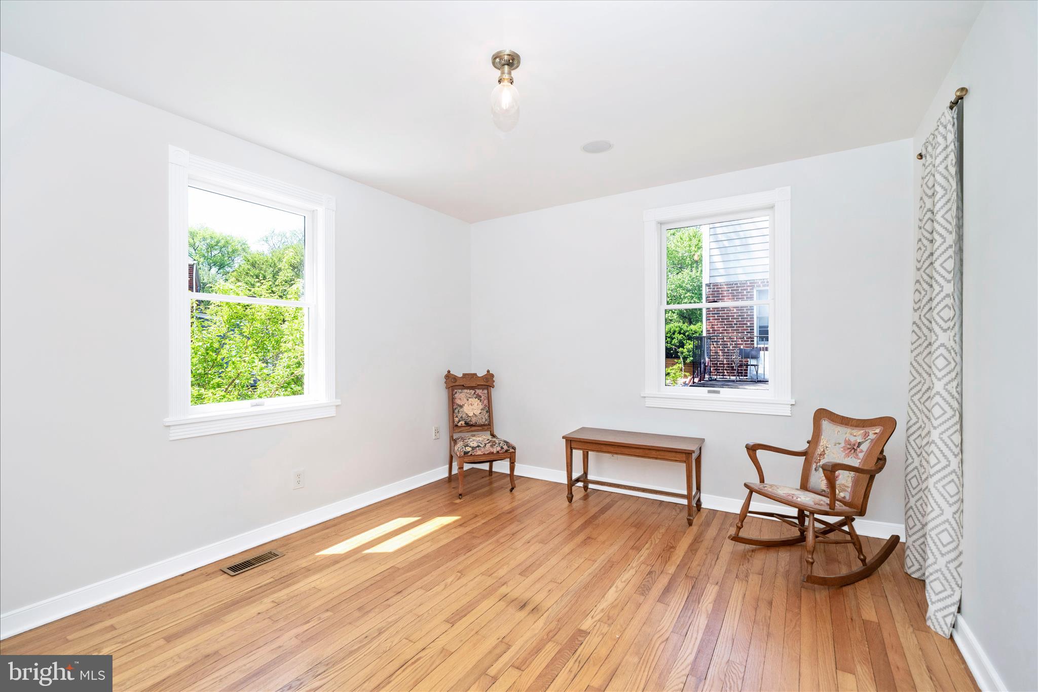 9300 Mintwood Street Silver Spring, MD 20901 - Photo 23 of 115 a view of a room with wooden floor lounge chair and windows