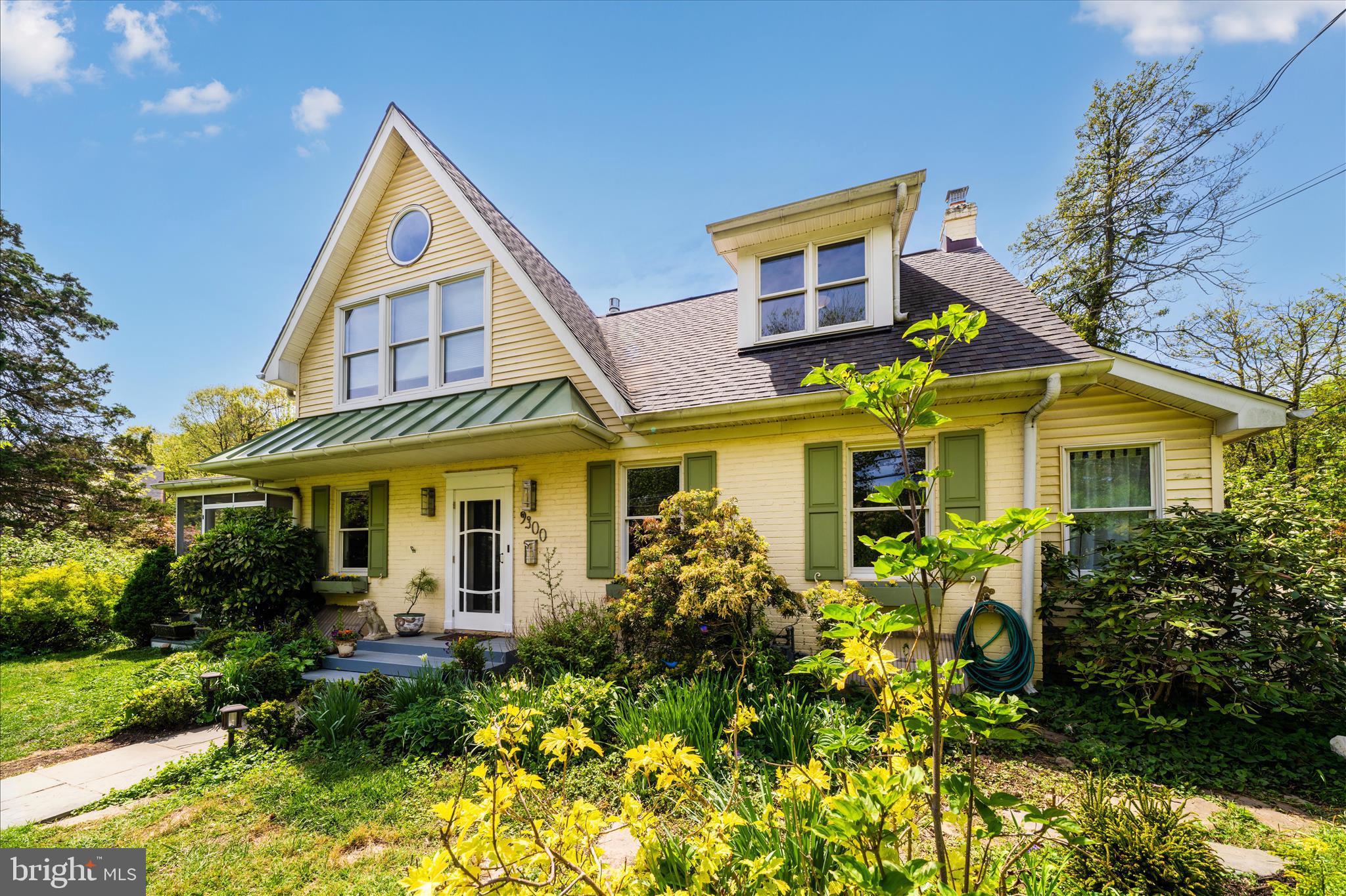 9300 Mintwood Street Silver Spring, MD 20901 - Photo 41 of 115 a view of a brick house with large windows and flower plants