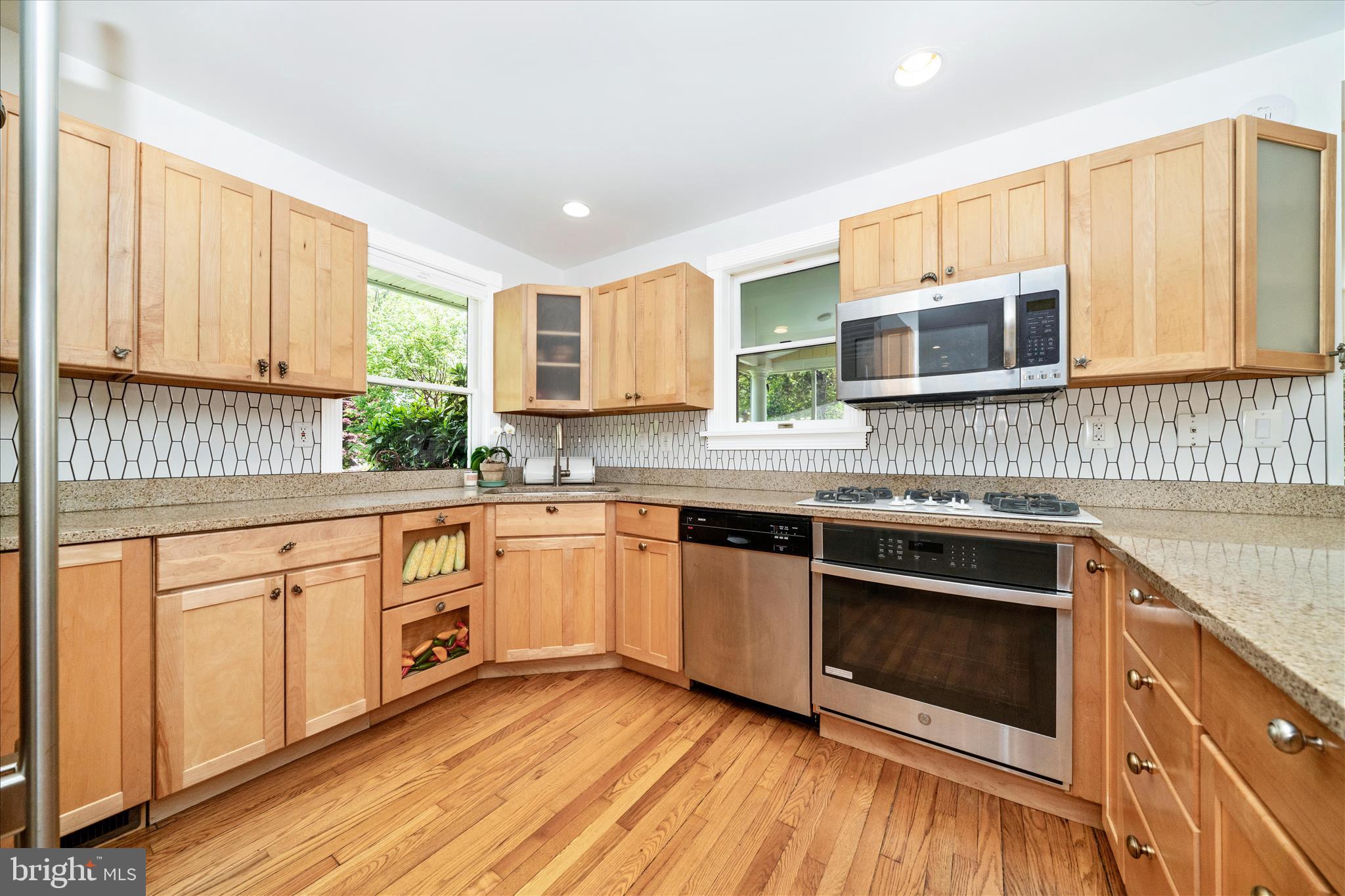 9300 Mintwood Street Silver Spring, MD 20901 - Photo 75 of 115 a kitchen with stainless steel appliances granite countertop a stove a sink and a microwave