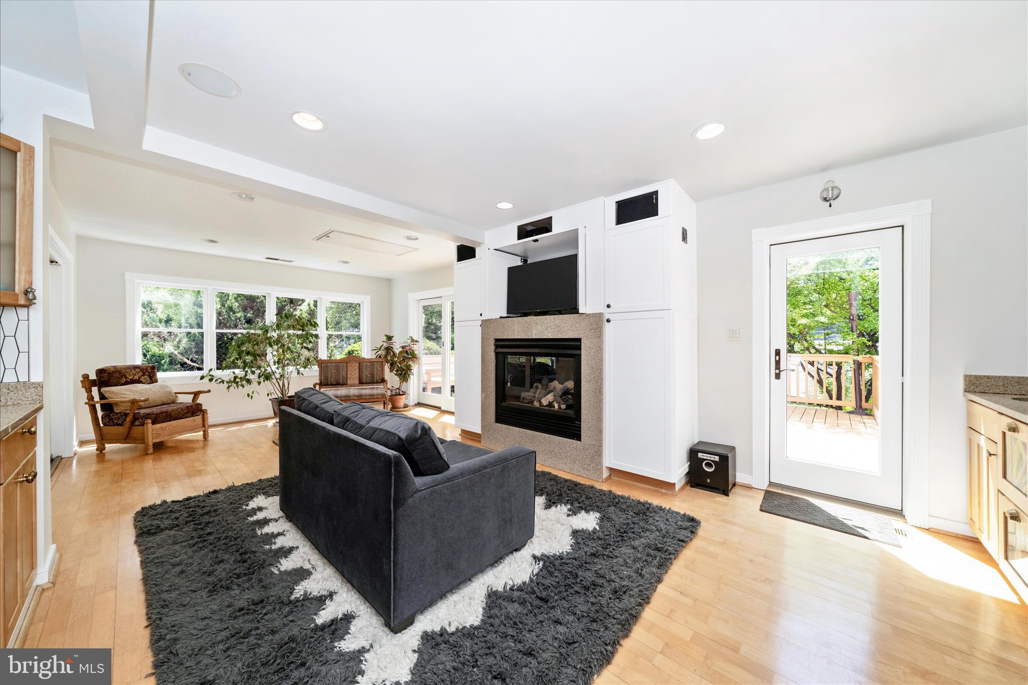 9300 Mintwood Street Silver Spring, MD 20901 - Photo 79 of 115 a living room with furniture large window and a fireplace