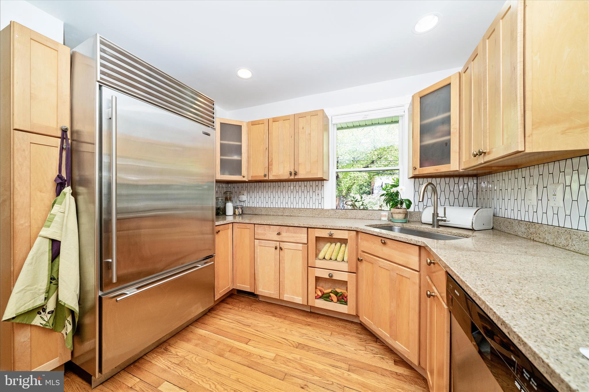9300 Mintwood Street Silver Spring, MD 20901 - Photo 10 of 115 a kitchen with granite countertop stainless steel appliances a sink window and cabinets