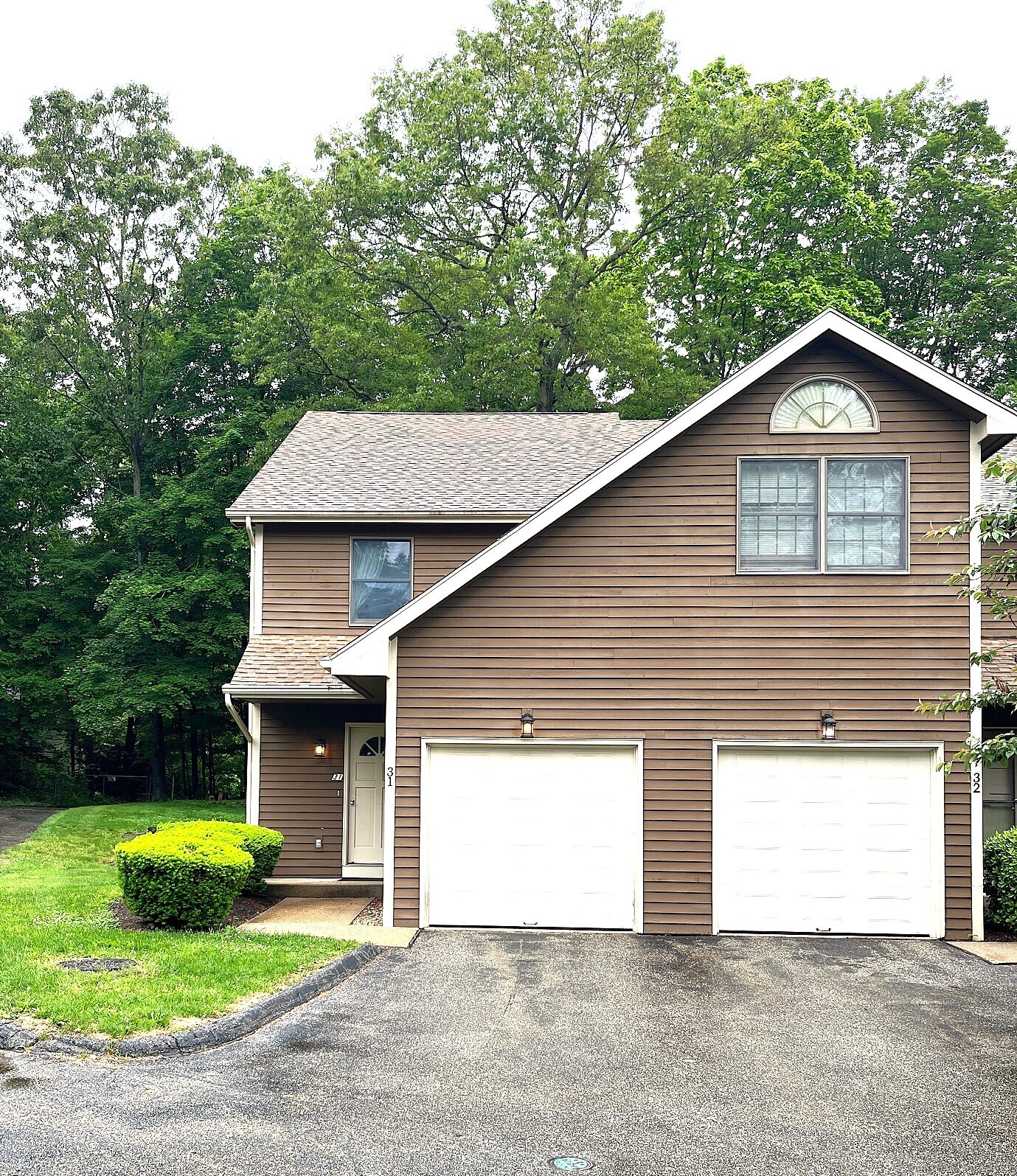 366 Ash Street, Unit 31 Windham, CT 06226 - Photo 1 of 1 a front view of a house with a yard and garage