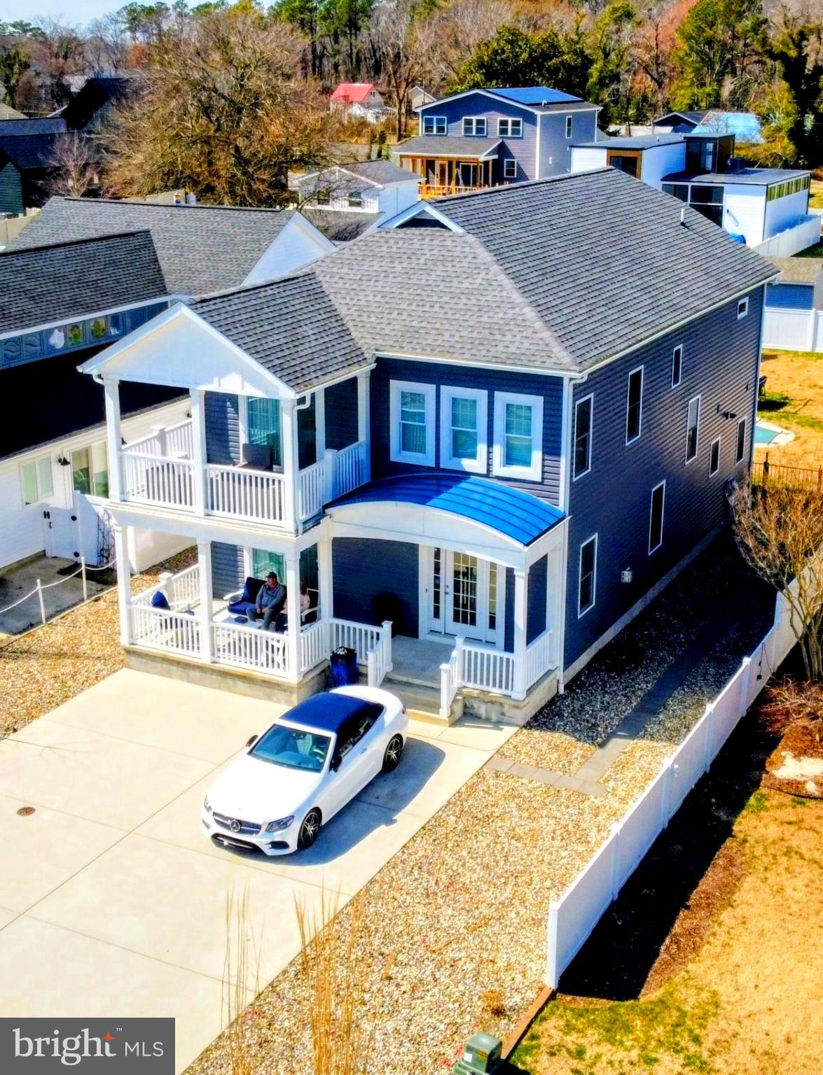 19798 Hebron Road Rehoboth Beach, DE 19971 - Photo 2 of 11 a aerial view of a house with swimming pool and porch