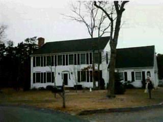 a view of a house with backyard porch and sitting area