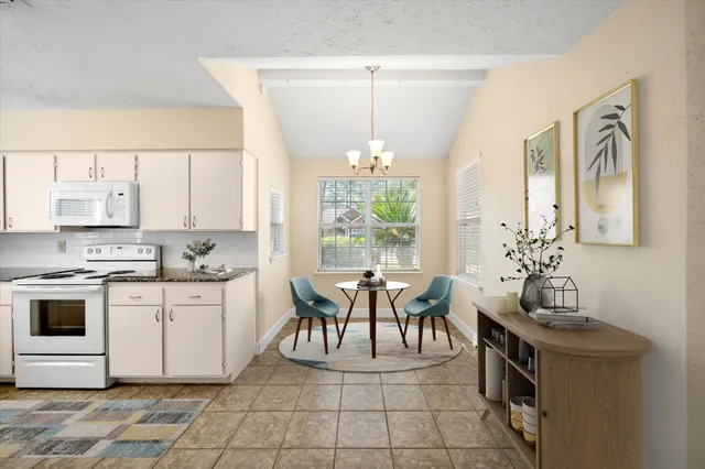 a view of a kitchen area with furniture and chandelier