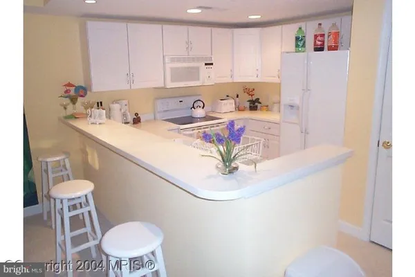 a kitchen with a sink cabinets and window