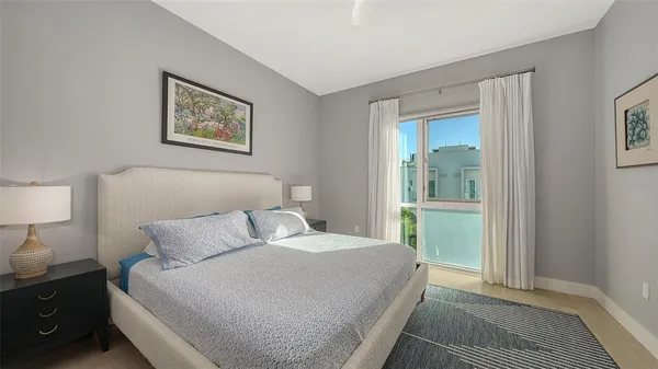 a bedroom with a bed and a lamp