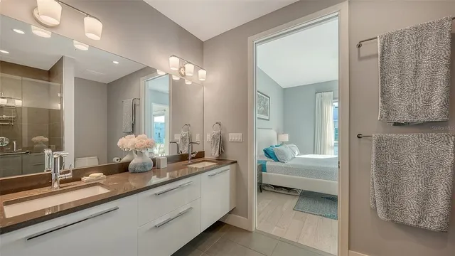 a bathroom with double vanity sinks and a mirror