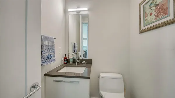 a bathroom with a toilet a sink and mirror
