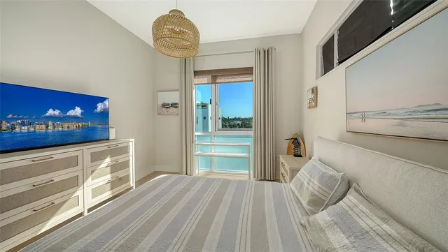 a bedroom with a bed and a chandelier