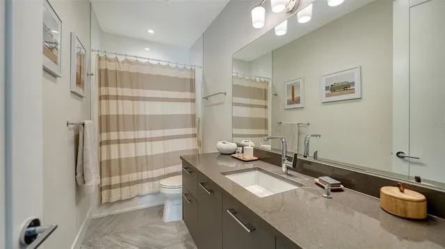 a bathroom with a double vanity sink mirror and double