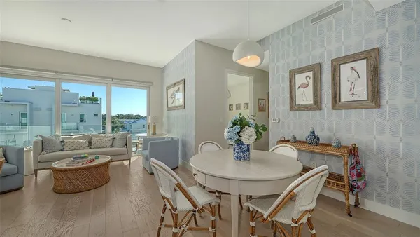 a view of a dining room with furniture and a potted plant