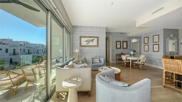 a living room with furniture and a floor to ceiling window