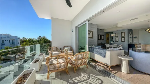 a dining room with furniture and a floor to ceiling window