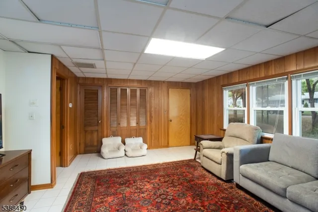 a bedroom with furniture and large windows