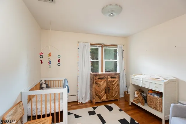 a bedroom with furniture and baby crib