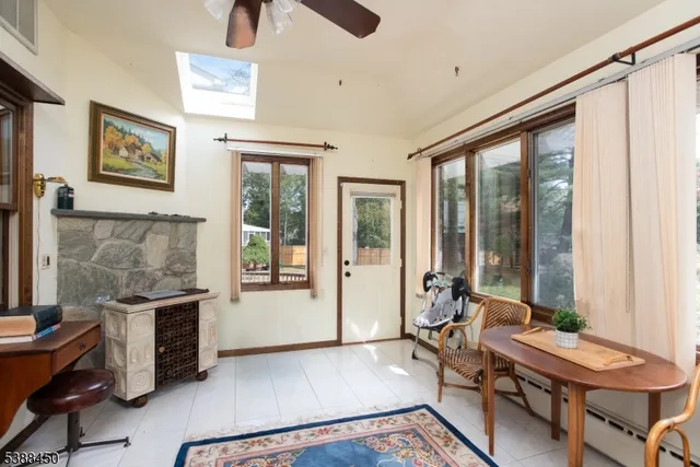 a living room with furniture and large windows