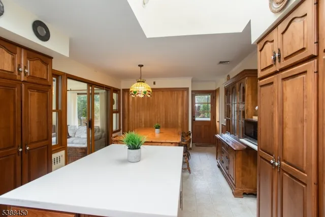 a large white kitchen with a large window