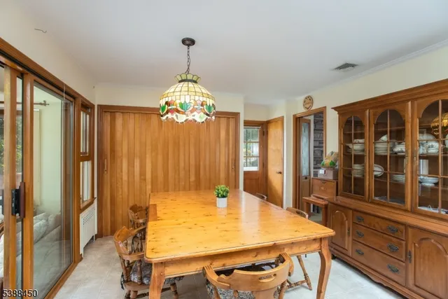 a view of a dining room with furniture and chandelier