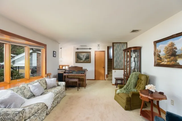 a living room with furniture and a piano