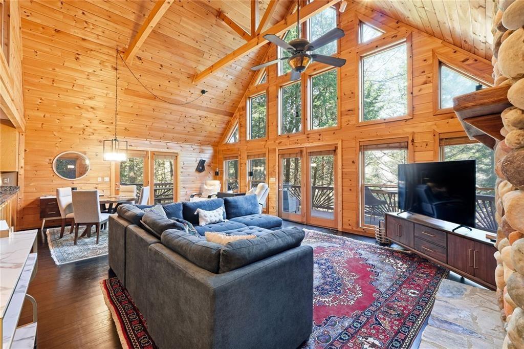 834 Indian Cave Road Ellijay, GA 30536 - Photo 11 of 44 a living room with fireplace furniture and a flat screen tv