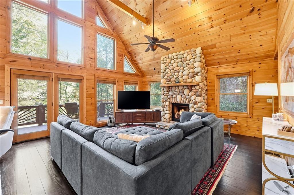 834 Indian Cave Road Ellijay, GA 30536 - Photo 12 of 44 a living room with fireplace furniture and a flat screen tv
