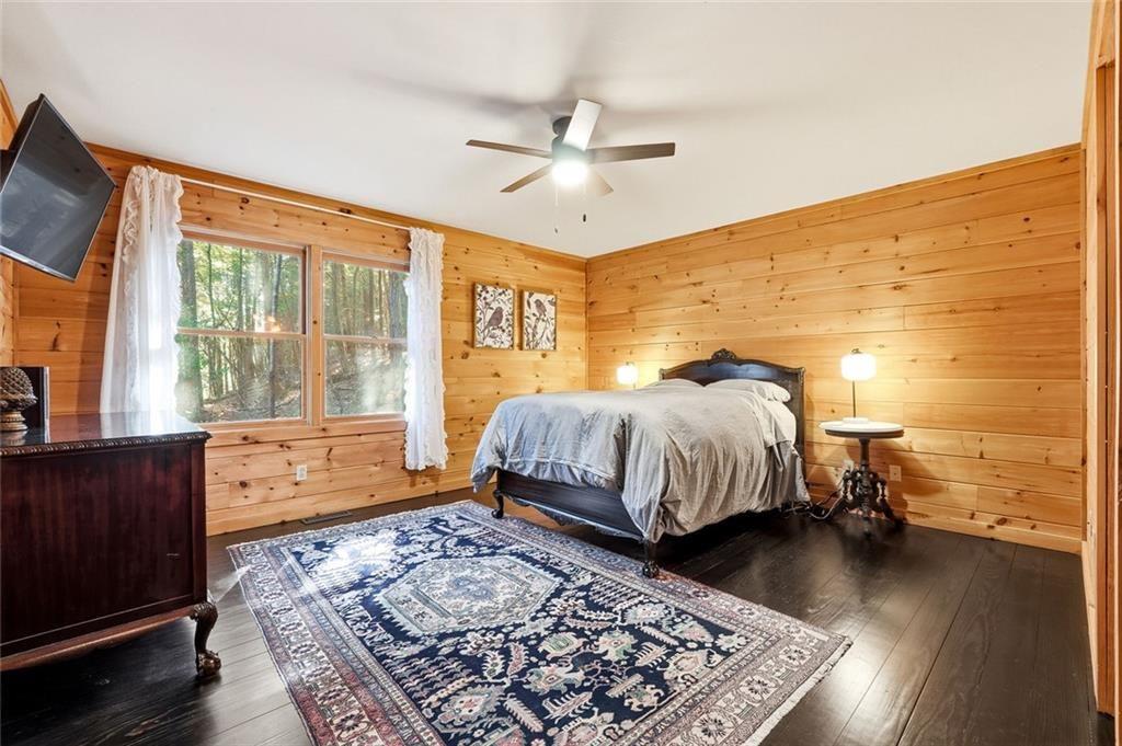 834 Indian Cave Road Ellijay, GA 30536 - Photo 13 of 44 a bedroom with a bed and wooden floor