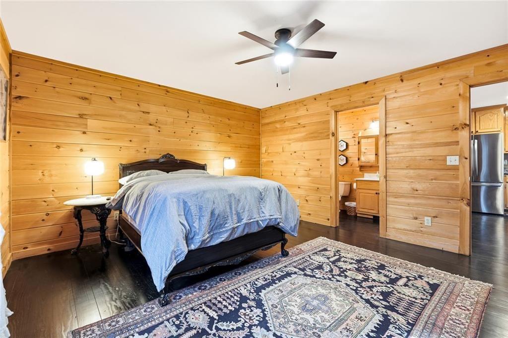 834 Indian Cave Road Ellijay, GA 30536 - Photo 15 of 44 a bedroom with a bed and a walk in closet