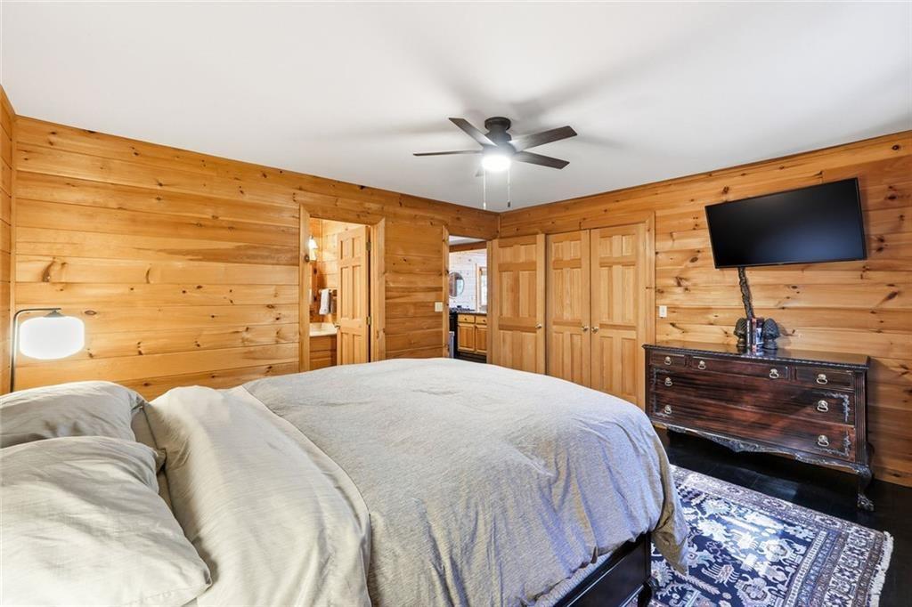 834 Indian Cave Road Ellijay, GA 30536 - Photo 16 of 44 a bedroom with a bed and a flat screen tv