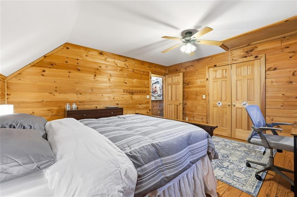 834 Indian Cave Road Ellijay, GA 30536 - Photo 21 of 44 a bedroom with a bed and a chandelier