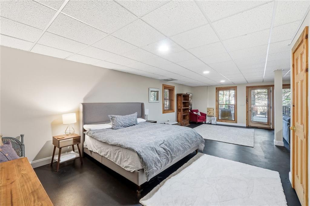 834 Indian Cave Road Ellijay, GA 30536 - Photo 26 of 44 a bedroom with a large bed and a chandelier