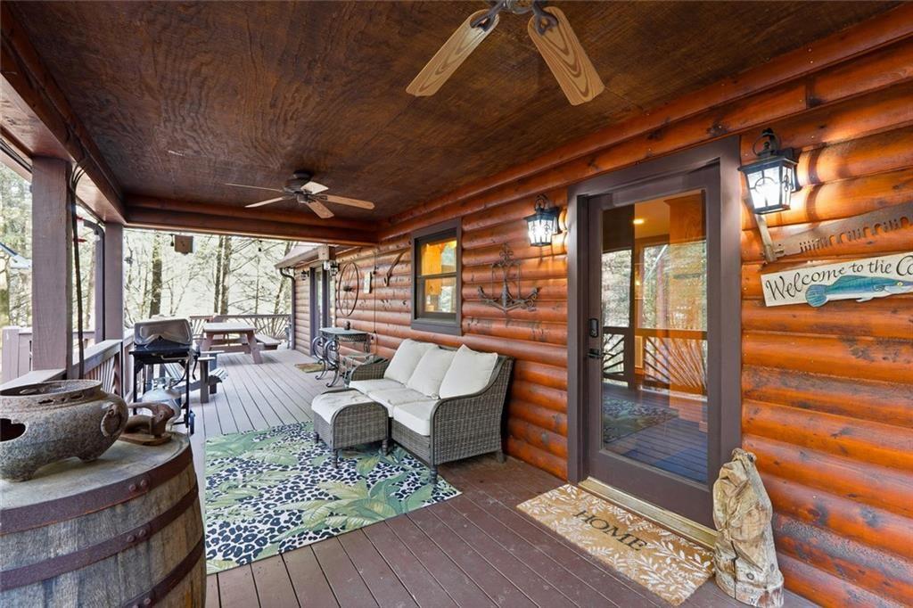 834 Indian Cave Road Ellijay, GA 30536 - Photo 30 of 44 a living room with furniture and a floor to ceiling window