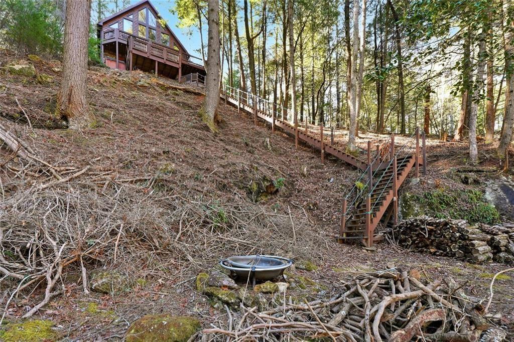 834 Indian Cave Road Ellijay, GA 30536 - Photo 39 of 44 a backyard of a house with table and chairs